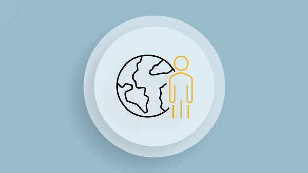 Symbolic image showing a globe with a person standing next to it.