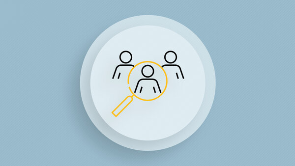 Symbolic image with a magnifying glass that has three people in its search field.